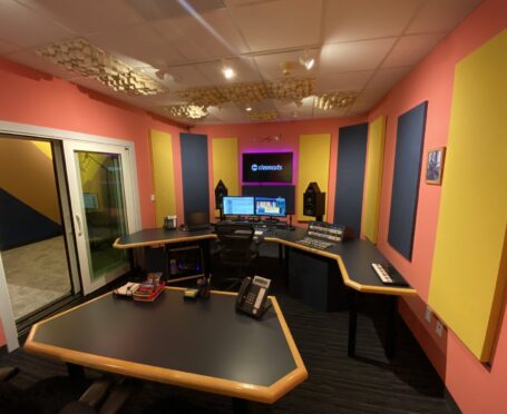photo of new Dolly Parton suite in our Washington, DC studios. colorful acoustical panels on the wall with two desks and computer monitors.