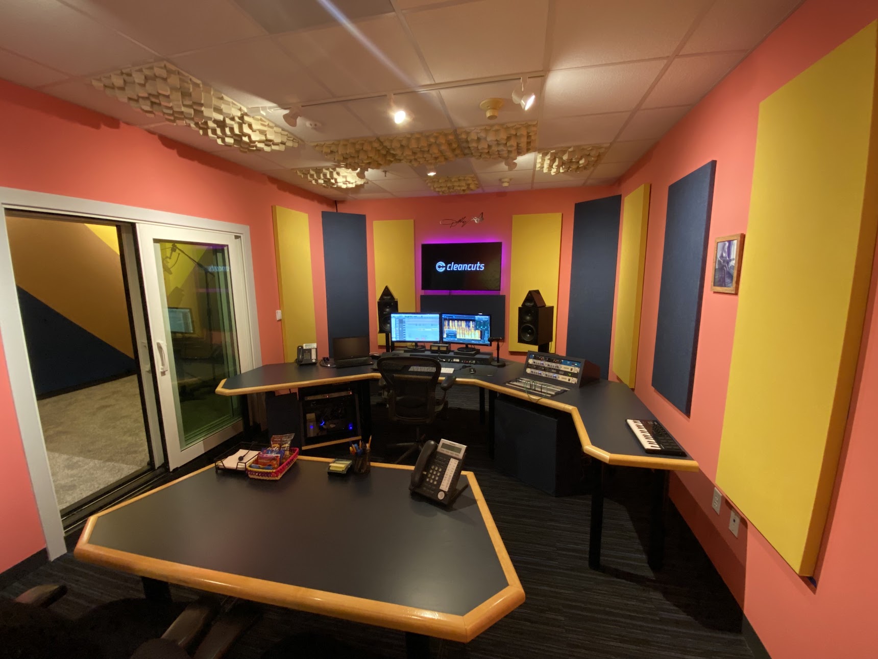 photo of new Dolly Parton suite in our Washington, DC studios. colorful acoustical panels on the wall with two desks and computer monitors.